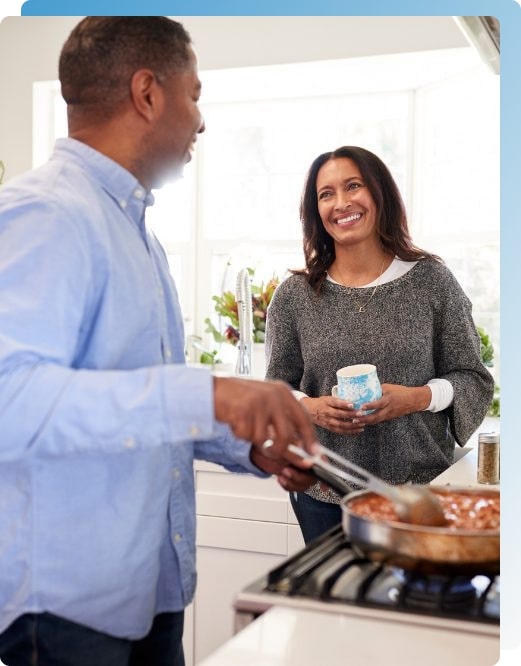 A couple cooking together talking about how to improve their marriage